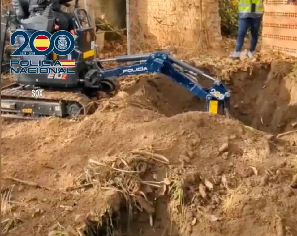 Police using a small excavator at a dig site.