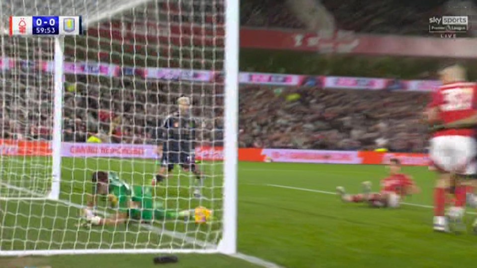 Emiliano Martínez making a save during a soccer game.