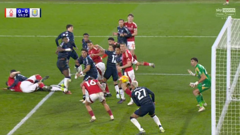Emiliano Martinez making a save during a soccer game.