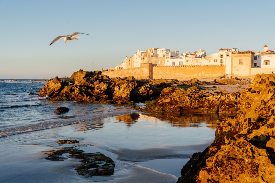Essaouira, Morocco: sunset over the city walls and beach.