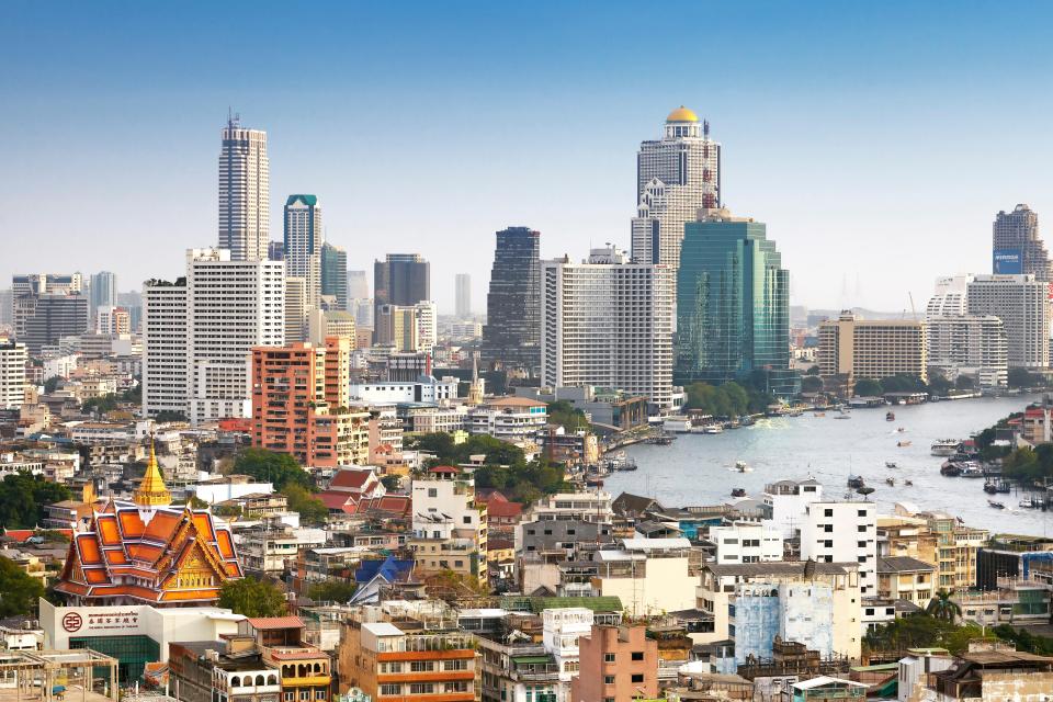Bangkok skyline with river and buildings.