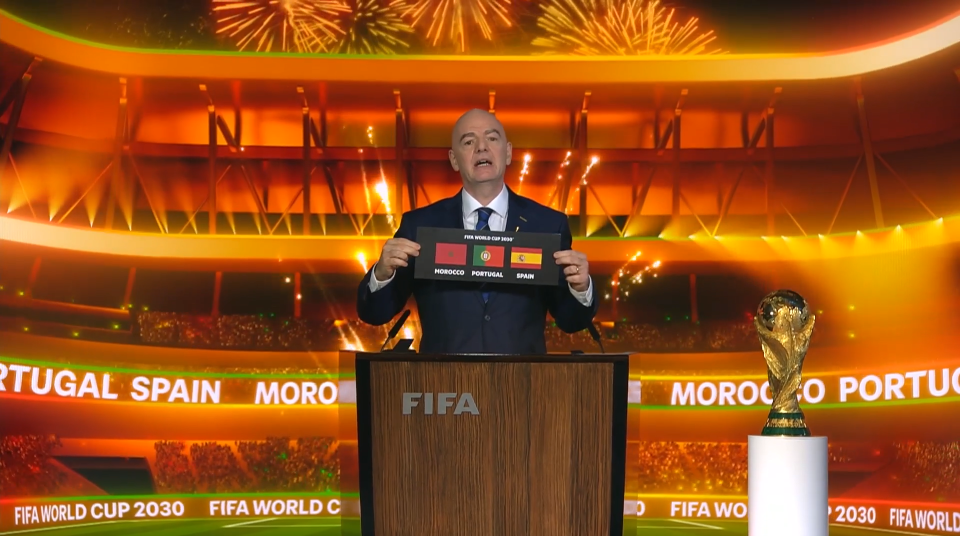 FIFA official announcing Morocco, Portugal, and Spain as 2030 World Cup co-hosts.