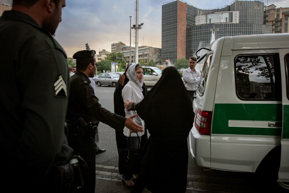 Iranian morality police detaining women for violating hijab laws.