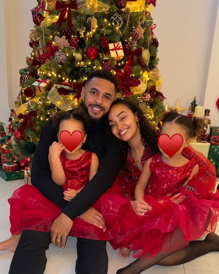 Leigh-Anne Pinnock and her family pose for a Christmas photo in front of a decorated tree.
