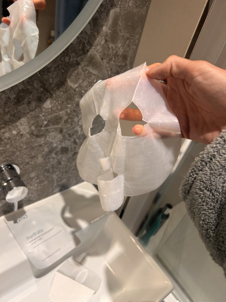 Person holding a sheet mask.