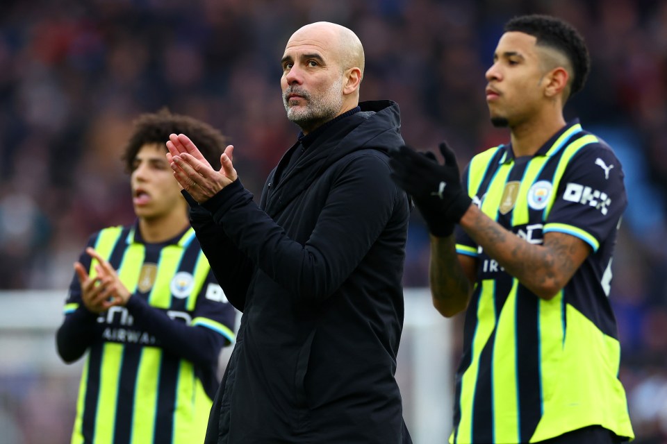 Pep Guardiola applauds with Manchester City players.