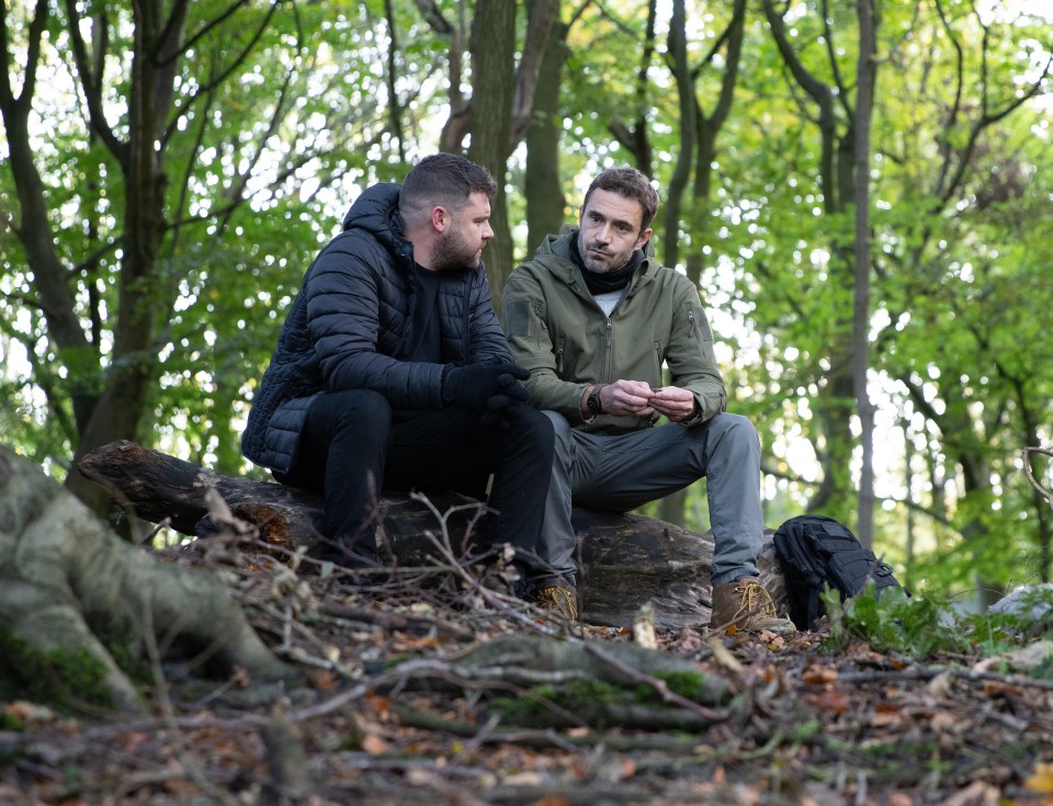 Two men sitting on a log in a forest confessing their love for each other.