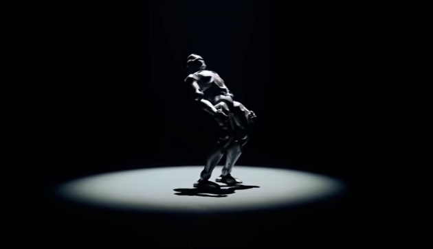 A robot performing an acrobatic pose.