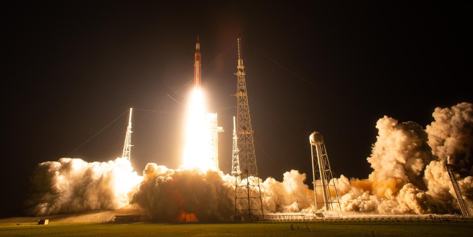 SLS rocket launching at night.