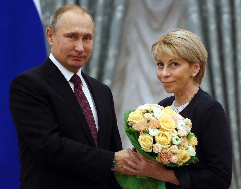 Vladimir Putin presenting flowers to Yelizaveta Glinka at an awards ceremony.