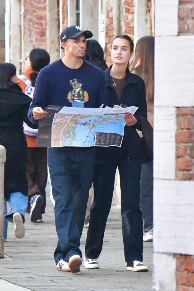 Trent Alexander-Arnold and Estelle Behnke sightseeing in Venice, Italy, using a map.