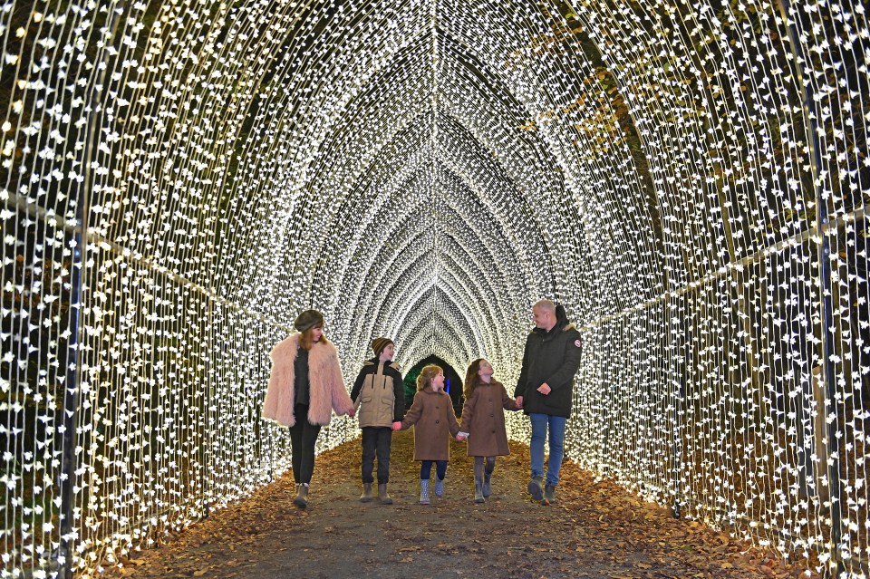 Family walking through a lighted tunnel.