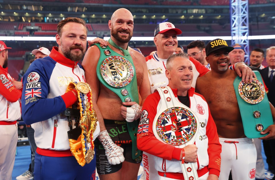 Tyson Fury celebrates his WBC World Heavyweight Title victory with his team at Wembley Stadium.