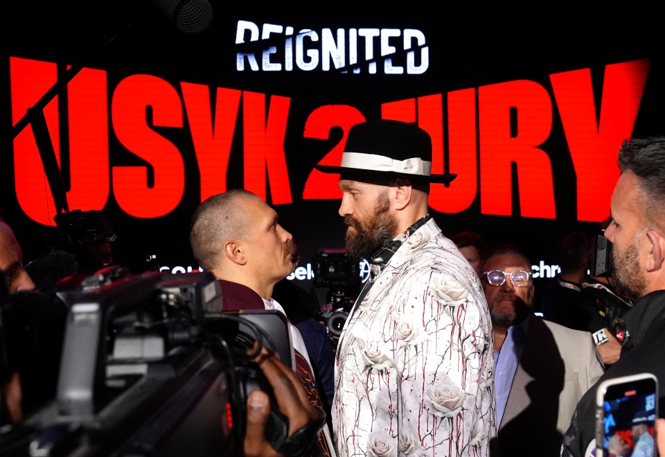Oleksandr Usyk and Tyson Fury face off at a press conference.