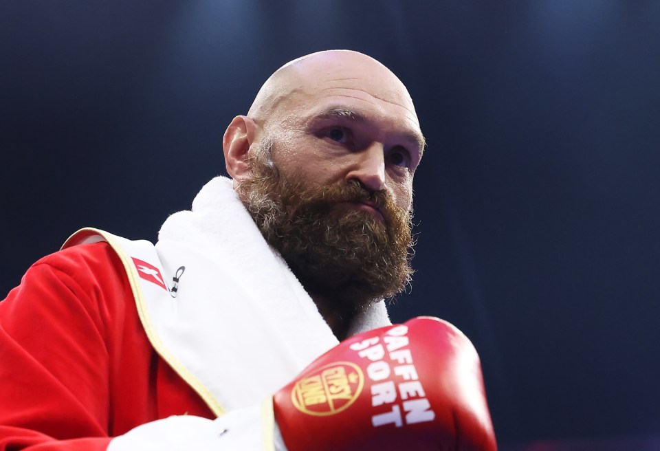 Tyson Fury in boxing robe and glove before a fight.