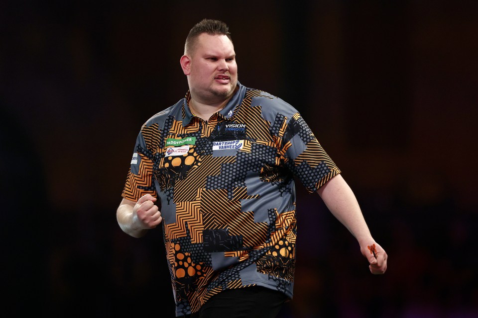 Wesley Plaisier of the Netherlands celebrates during a darts match.