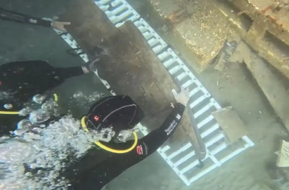 Divers recovering a 2,600-year-old Phoenician shipwreck.