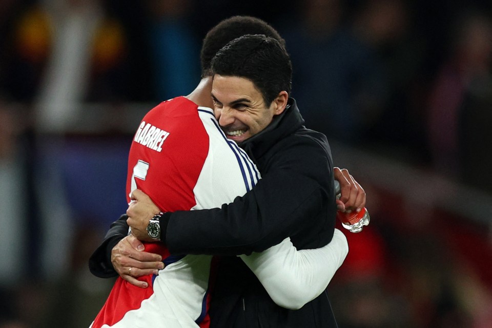 Mikel Arteta hugging Gabriel Magalhaes after an Arsenal win.