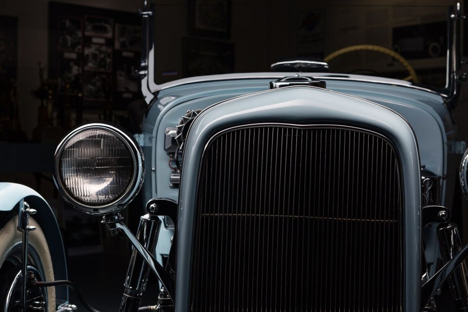 Close-up of a restored 1932 Ford hot rod's front grill and headlight.
