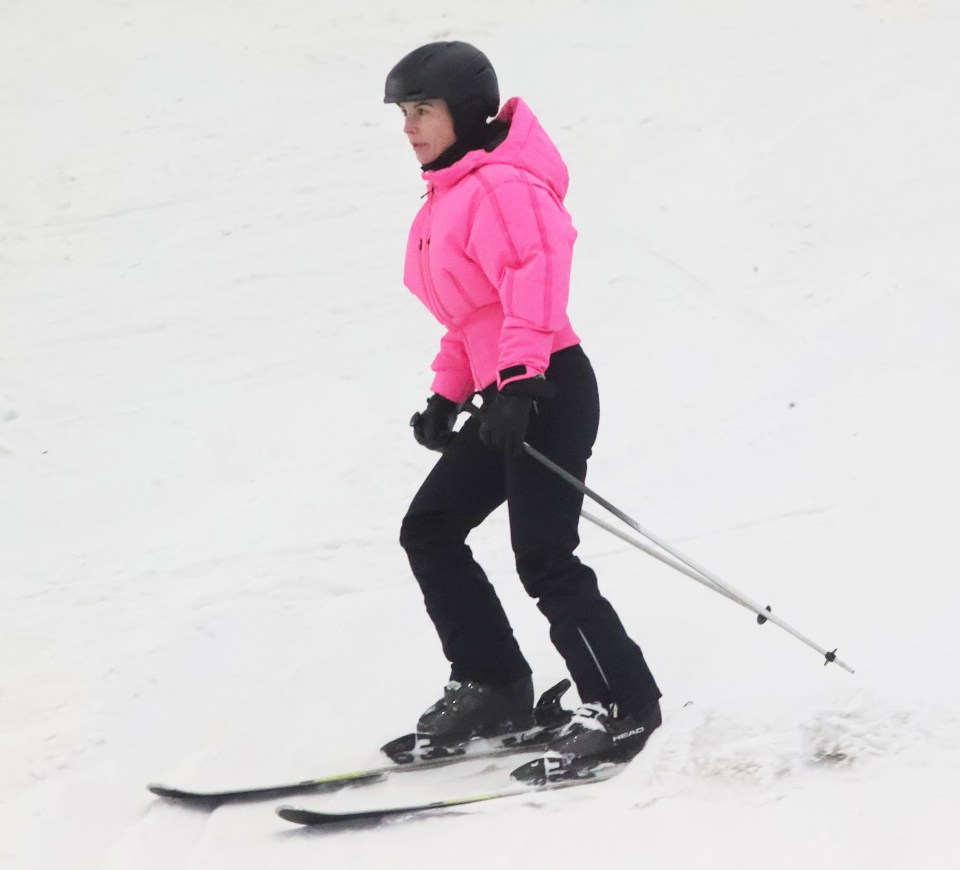 Coleen Rooney skiing in a pink jacket.