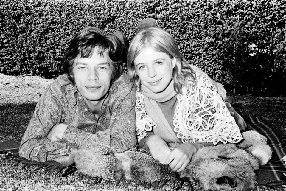 Black and white photo of Mick Jagger and Marianne Faithfull lying down together.