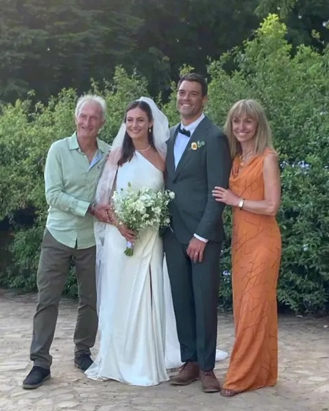 Michaela Strachan's wedding photo with her new husband, parents, and bridal party.
