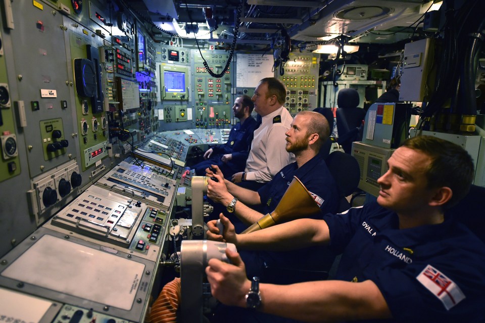 Royal Navy personnel in the control room of HMS Vigilant submarine.