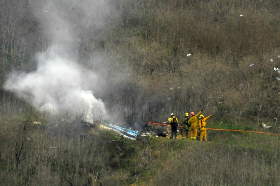 Firefighters at the site of a helicopter crash.