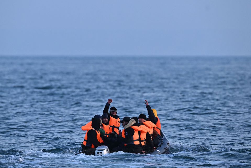 Migrants in a small inflatable boat crossing the English Channel.
