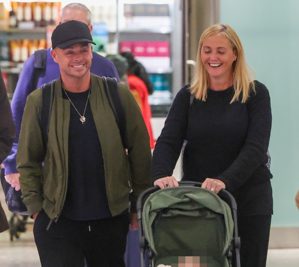 Ant McPartlin and his wife Anne-Marie Corbett arrive at an airport with their newborn baby.