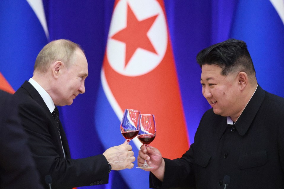 Vladimir Putin and Kim Jong Un toasting with wine.