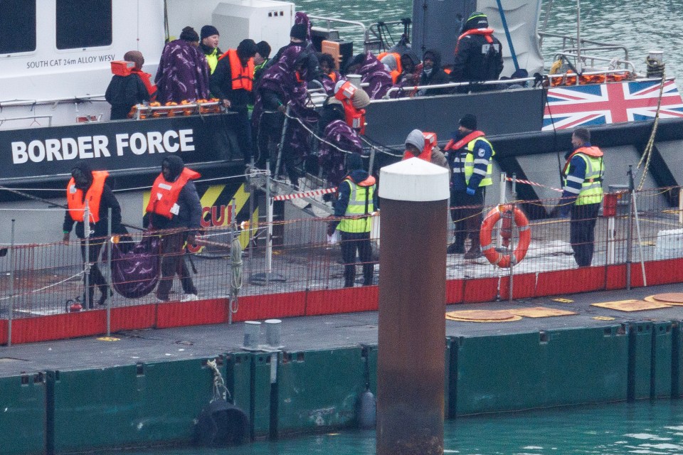 Migrants arriving at Dover port on a Border Force vessel.