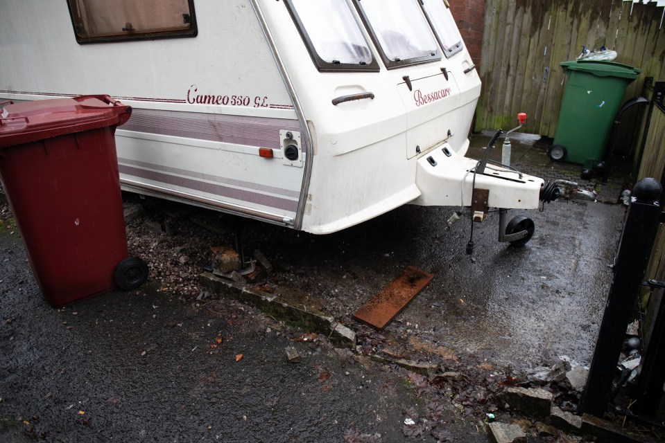 Caravan parked in a front garden, causing complaints from neighbors.
