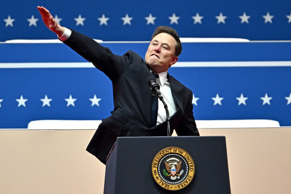 Elon Musk giving a speech at an inauguration, making a hand gesture.