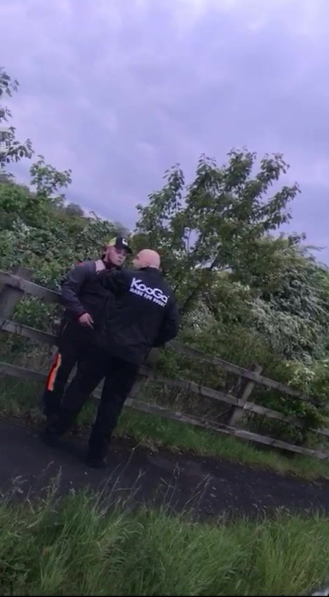 Video still of a police officer grabbing a man by the throat.