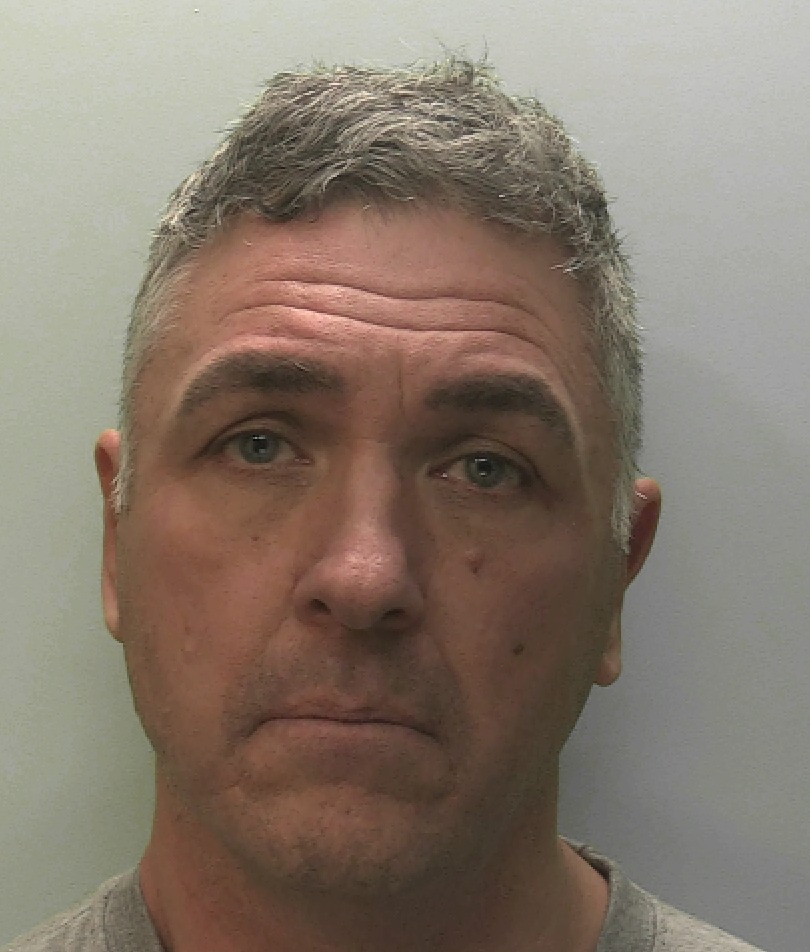 Mugshot of a man with short, graying hair.
