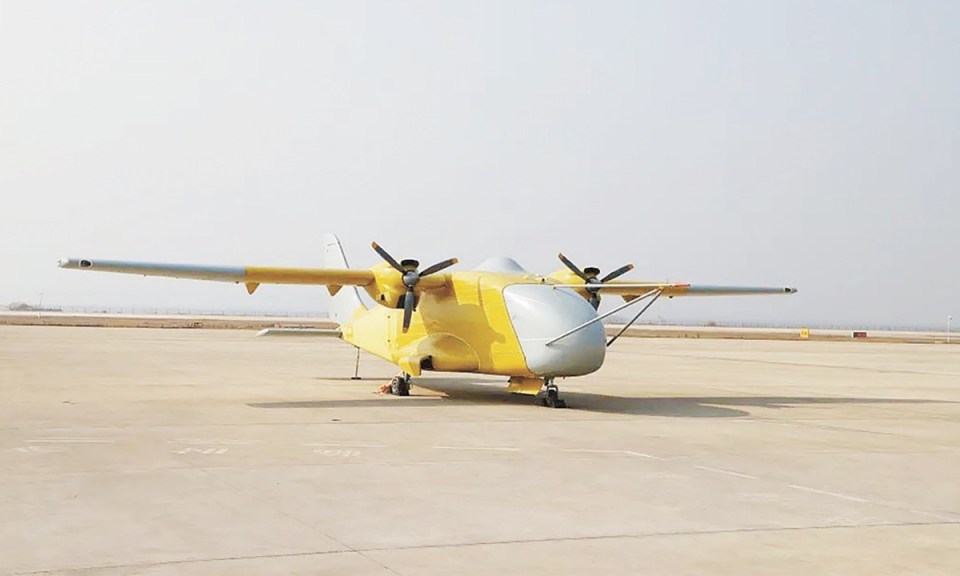 Yellow and gray twin-engine aircraft on tarmac.