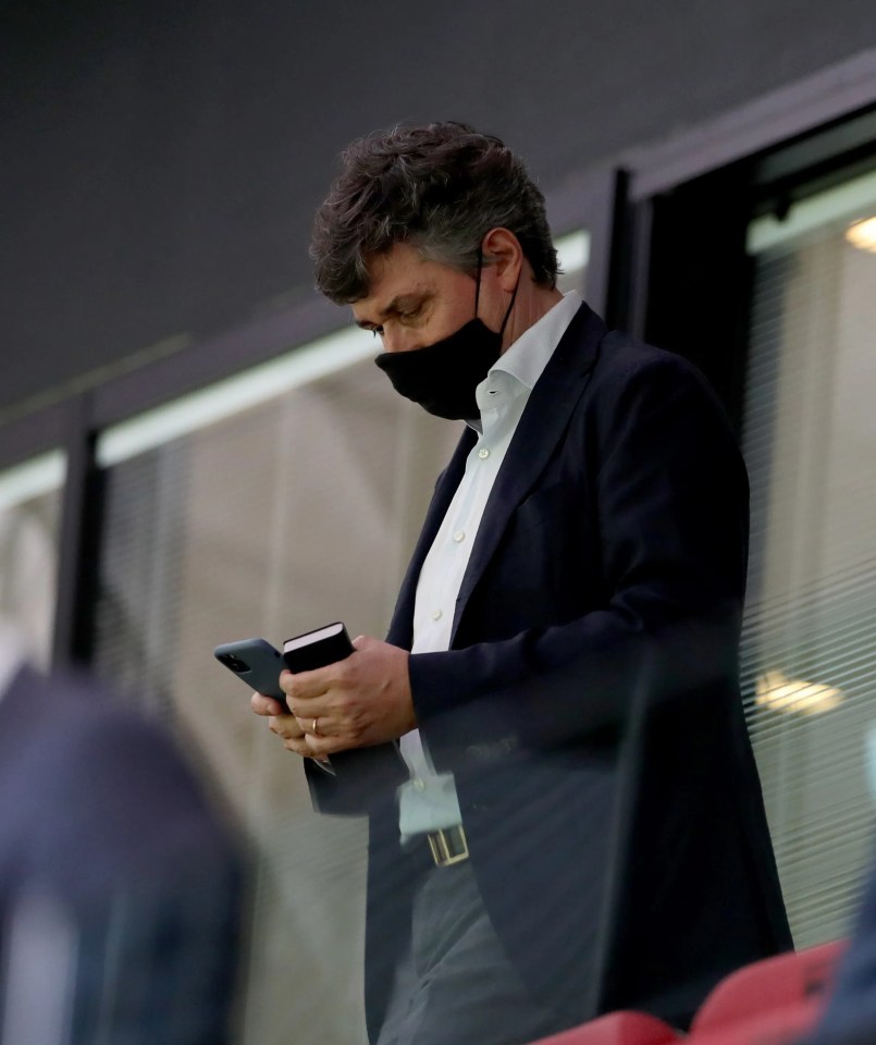 Gino Pozzo, Watford owner, in the directors box looking at his phone while wearing a face mask.