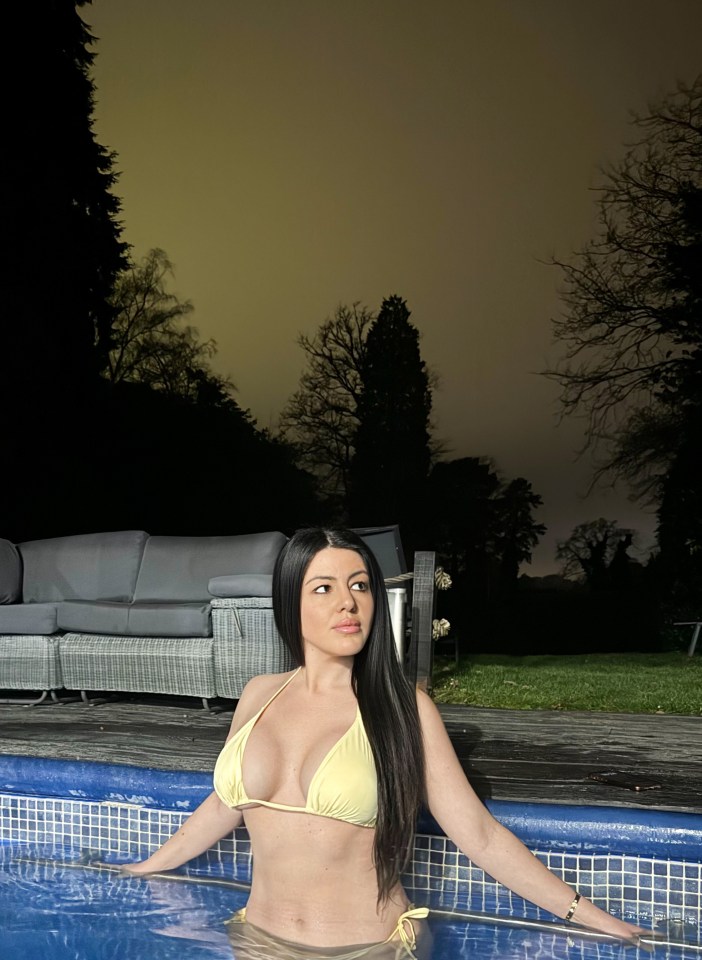 Woman in yellow bikini in a pool at night.