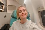 Woman smiling on airplane.