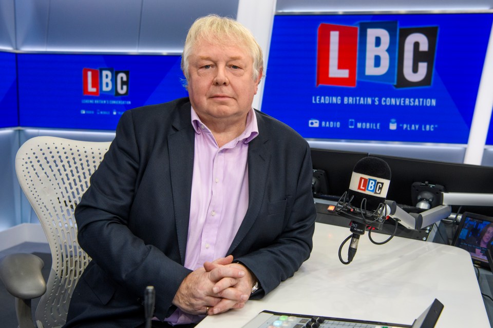 A man sits at a desk in an LBC radio studio.