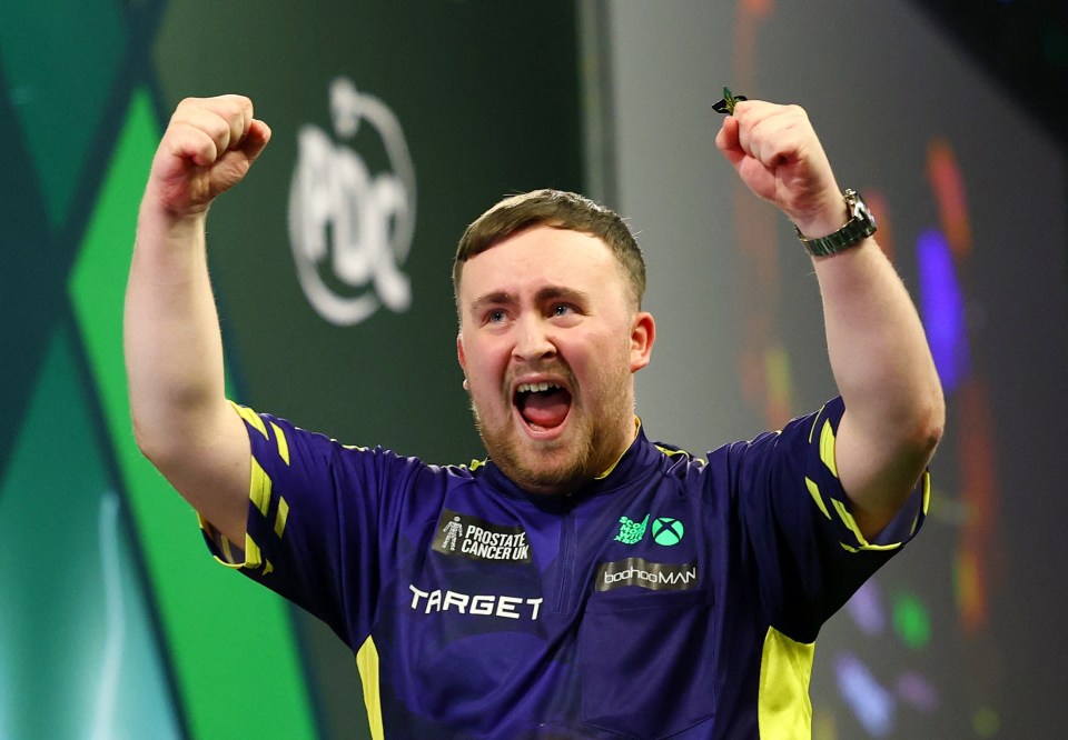 Luke Littler celebrates winning his World Darts Championship semi-final match.