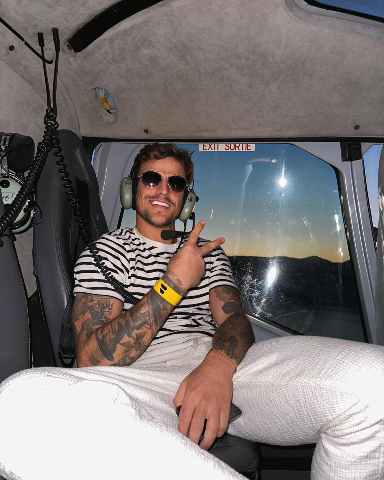 Man in helicopter making peace sign.