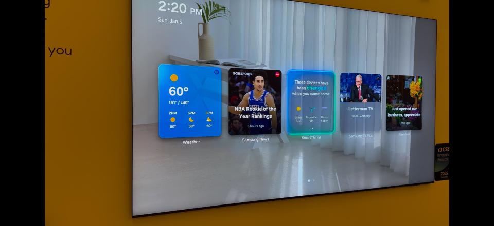 Smart TV home screen displaying weather, news, and smart home controls.
