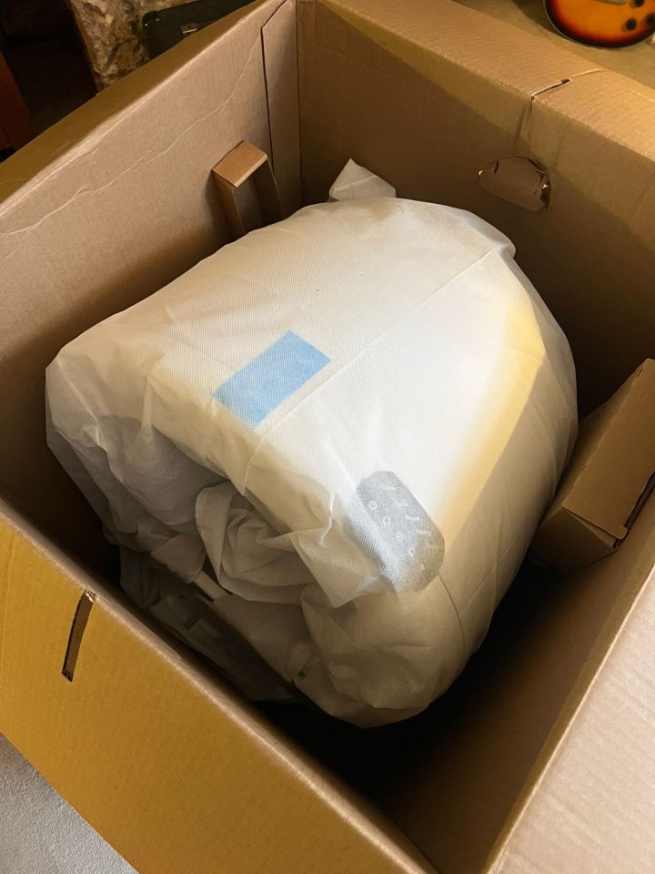 A white appliance in a cardboard box.