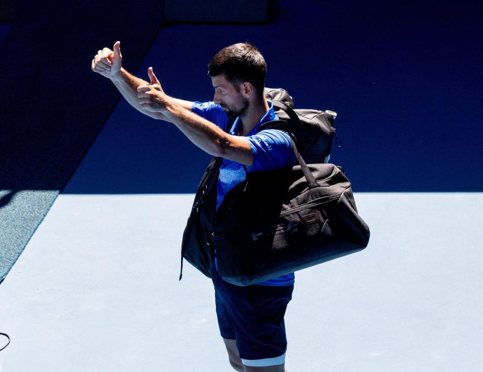 Novak Djokovic giving a thumbs-up to the audience.