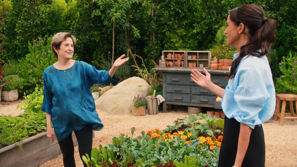 Alice Waters and Meghan, Duchess of Sussex, in a garden.