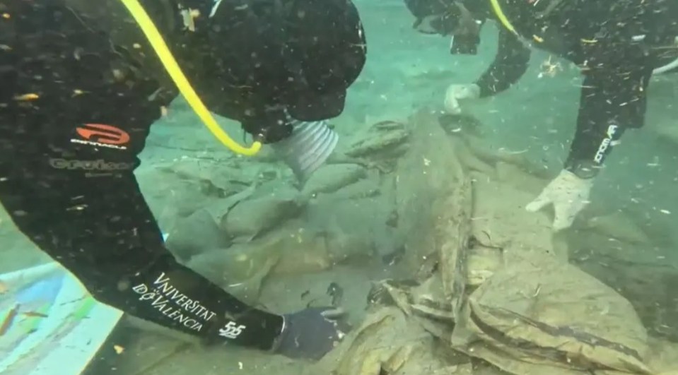 Divers excavating a 2,600-year-old Phoenician shipwreck.
