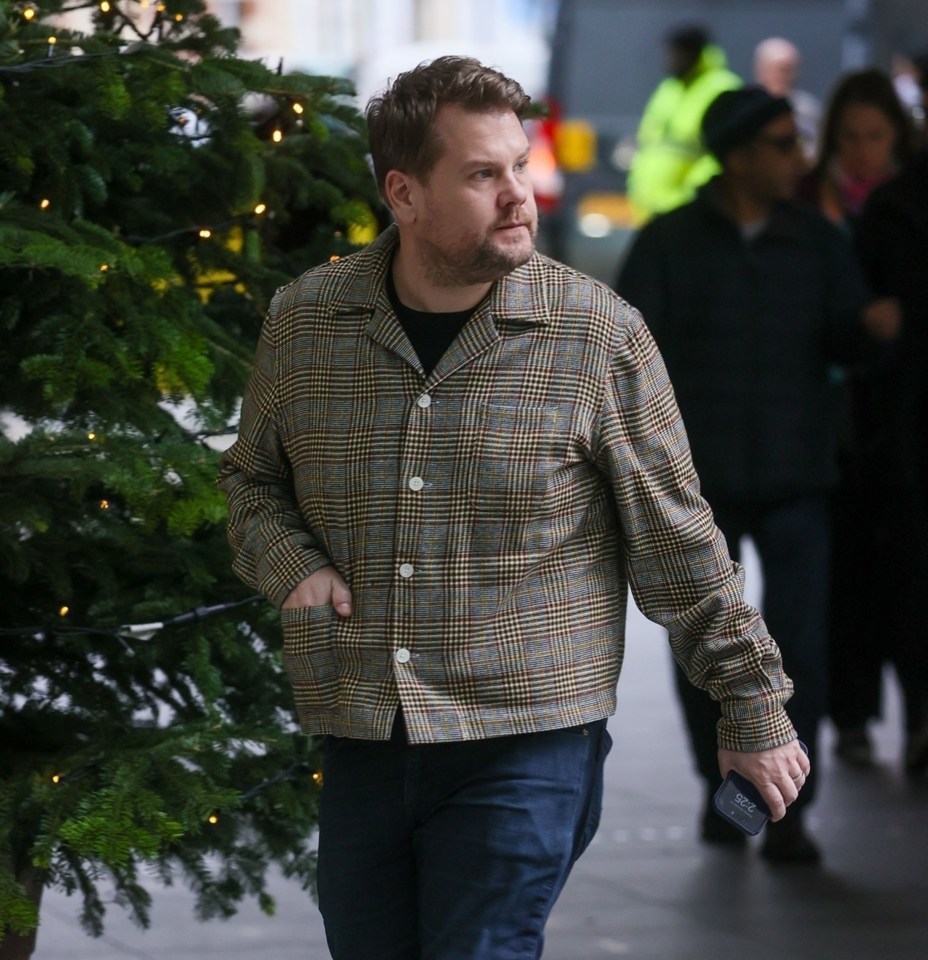 James Corden walking outside BBC Studios.