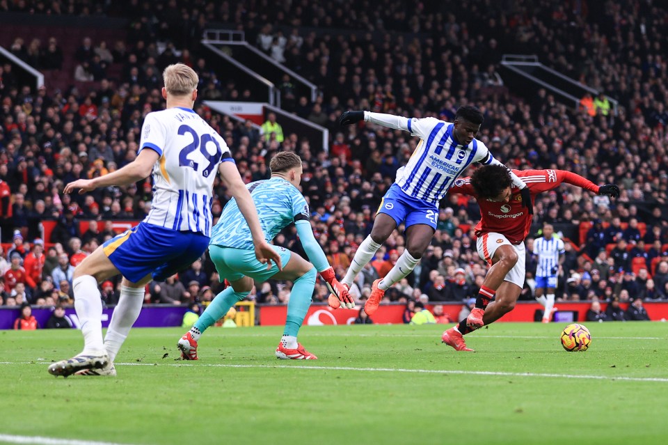 Carlos Baleba of Brighton & Hove Albion fouls a Manchester United player during a Premier League match.